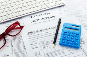 Tax concept with calculator and computer keyboard